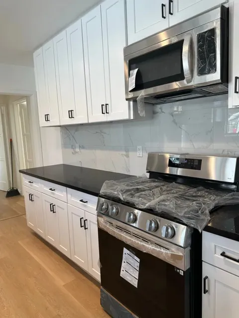 Kitchen renovation photo with upgraded layout, cabinetry and finish details