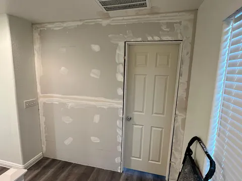 Drywall repair project photo showing wall or ceiling patch and finish work