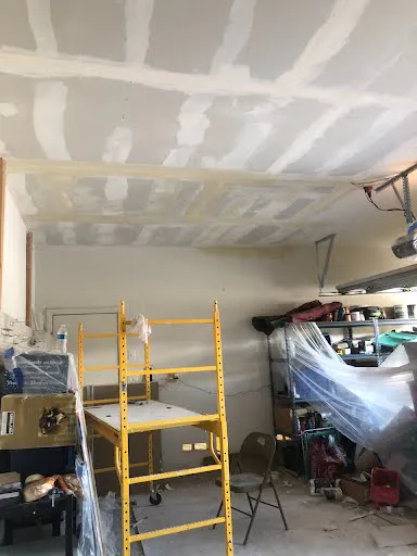 Drywall repair project photo showing wall or ceiling patch and finish work