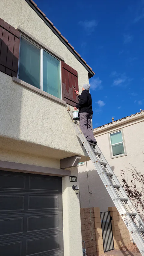 HOA violation repair project photo showing exterior stucco, paint or property correction work