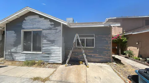 HOA violation repair project photo showing exterior stucco, paint or property correction work