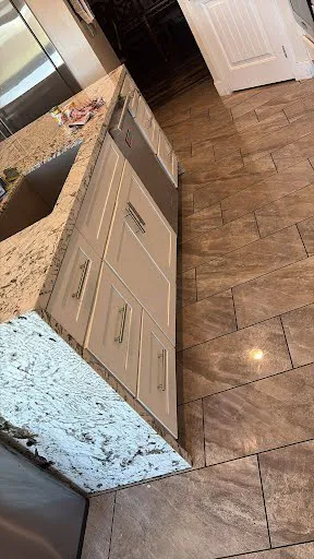 Kitchen remodeling project photo showing cabinets, countertops, backsplash and finish work
