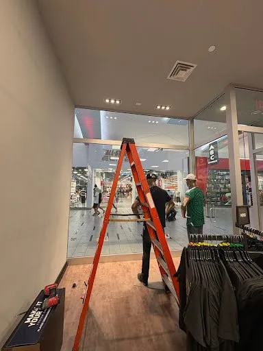 Retail store repair visit with ladder setup and interior maintenance work