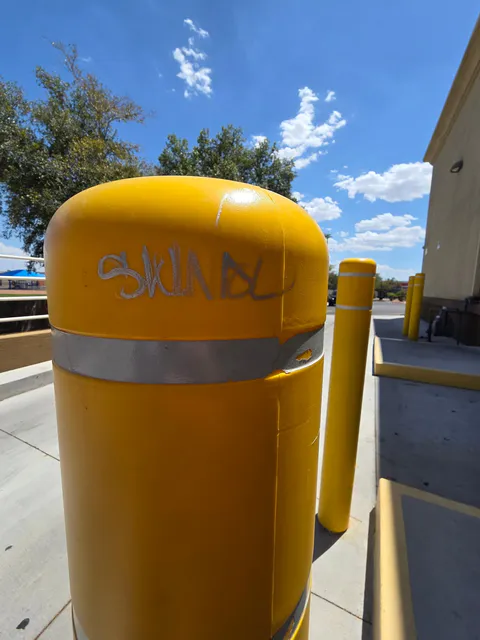 Commercial safety bollard graffiti cleanup and exterior maintenance photo