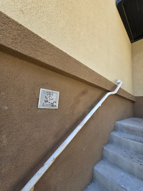 Commercial exterior stair rail and wall repair detail photo