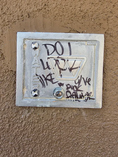 Commercial utility cover graffiti cleanup and wall repair photo