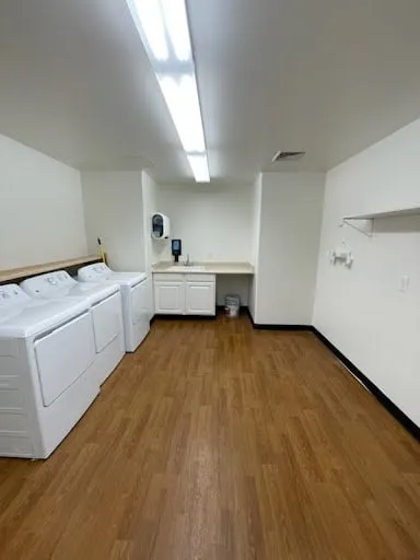 Commercial laundry room ceiling light and wall repair photo