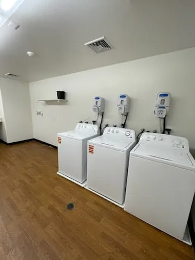 Commercial laundry room fixture wall and appliance area repair photo